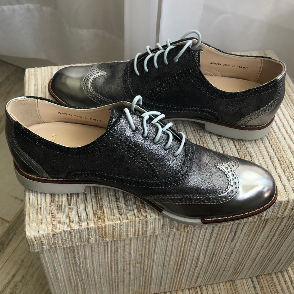 Cole Haan Metallic silver wing tip tie shoe.